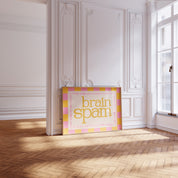 Brain Spam horizontal 24x36 mental health wall art poster leaning in a sunlit white paneled room on a herringbone wood floor