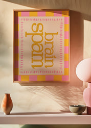 Brain Spam 24x36 mental health wall art poster framed on a warm blush wall above a pink shelf
