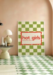 Hot Girls Read Fiction 24x36 bookish wall art poster leaning against a peach wall on a green checkered floor