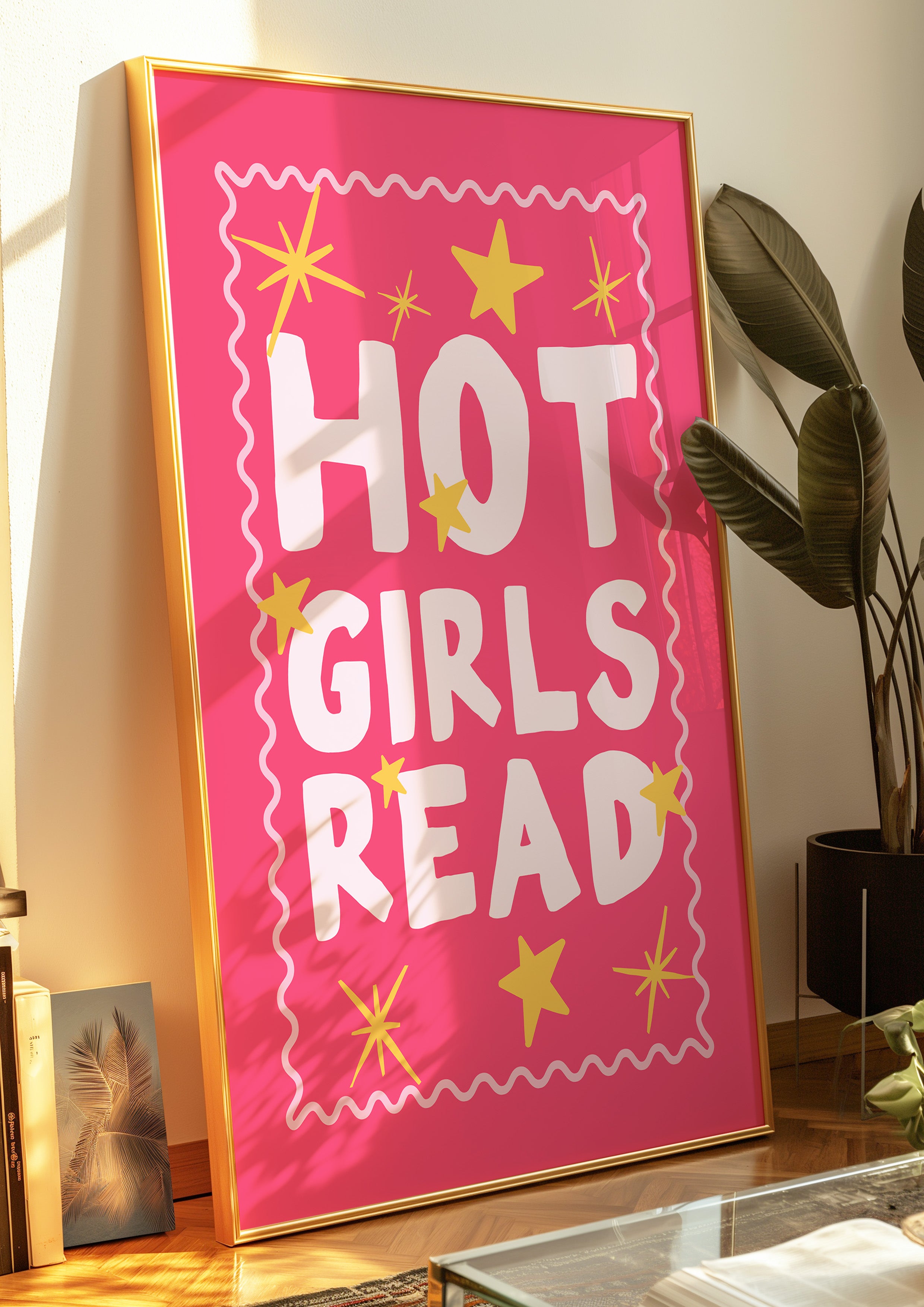 Hot Girls Read 24x36 bookish wall art poster leaning against a wall beside a potted plant