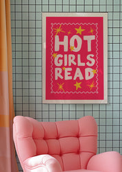 Hot Girls Read 24x36 bookish wall art poster framed above a pink armchair on a tiled wall