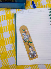Art Deco Citrus metal bookmark on a notebook on a yellow gingham blanket