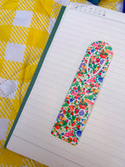 Botanical Garden floral metal bookmark on a lined notebook