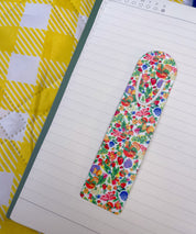 Botanical Garden floral metal bookmark on a lined notebook