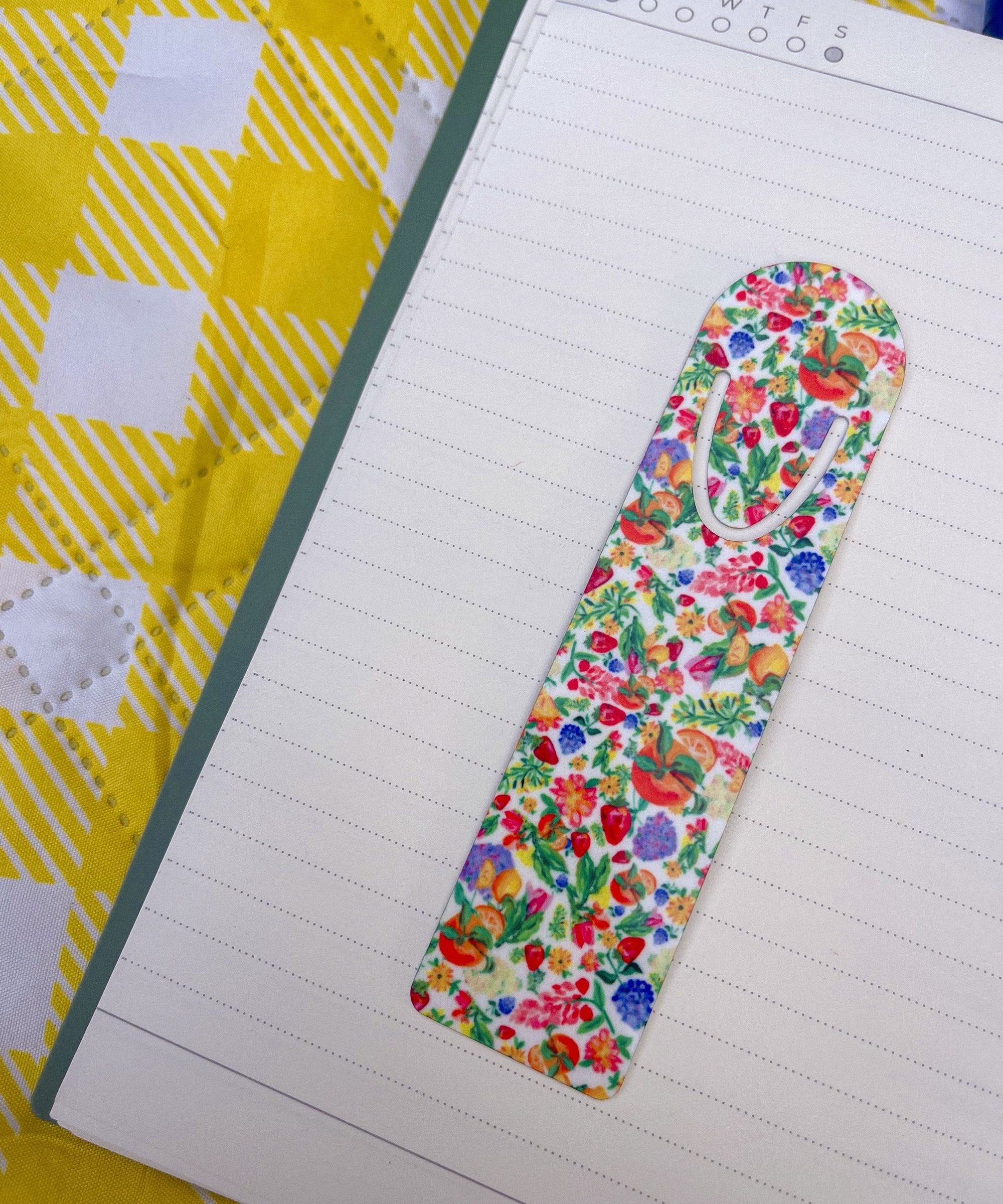 Botanical Garden floral metal bookmark on a lined notebook
