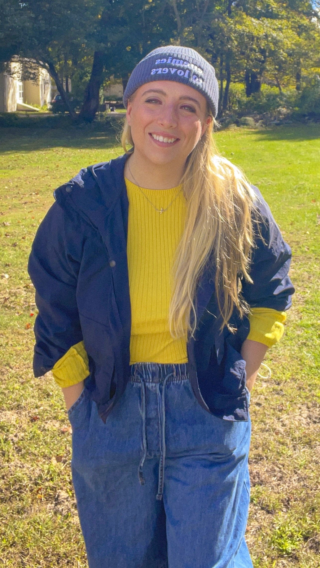 Enemies to Lovers fisherman beanie styled with a navy jacket and yellow sweater