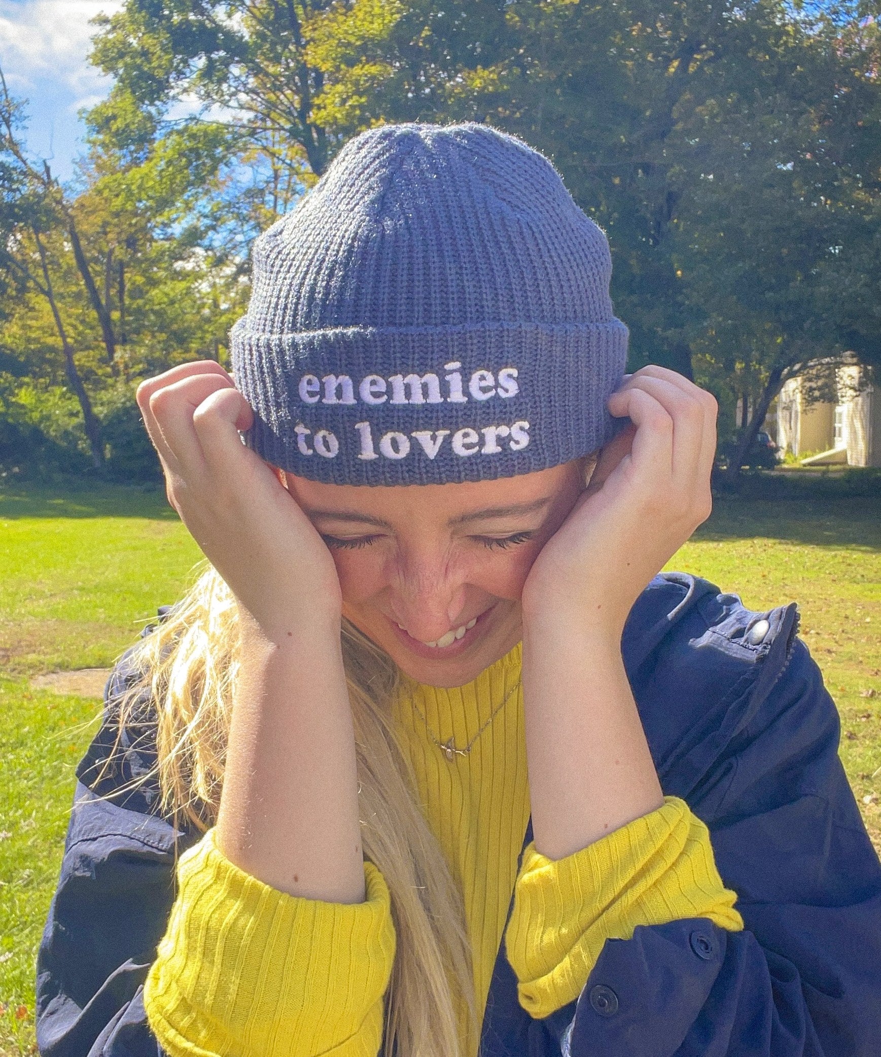 Woman wearing the navy Enemies to Lovers embroidered fisherman beanie