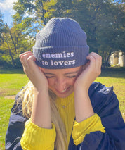 Woman wearing the navy Enemies to Lovers embroidered fisherman beanie