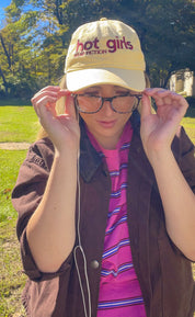 Woman in glasses wearing the Hot Girls Read Fiction coastal washed cap