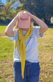 Woman adjusting the pink Reading Is My Favorite Sport coastal washed cap