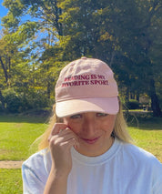 Woman wearing the pink Reading Is My Favorite Sport embroidered coastal washed cap