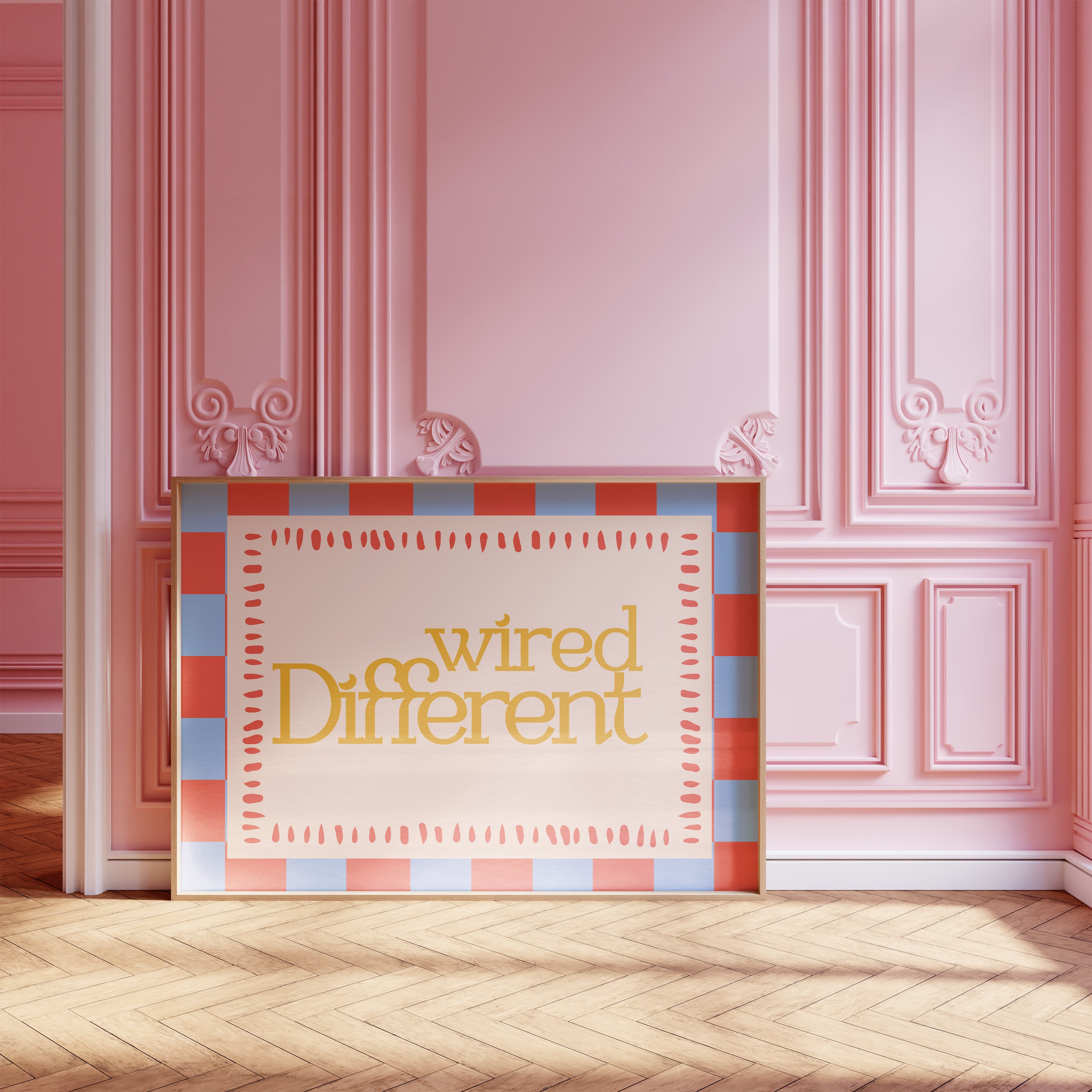 Wired Different horizontal 24x36 mental health wall art poster leaning against a pink paneled wall on a herringbone wood floor