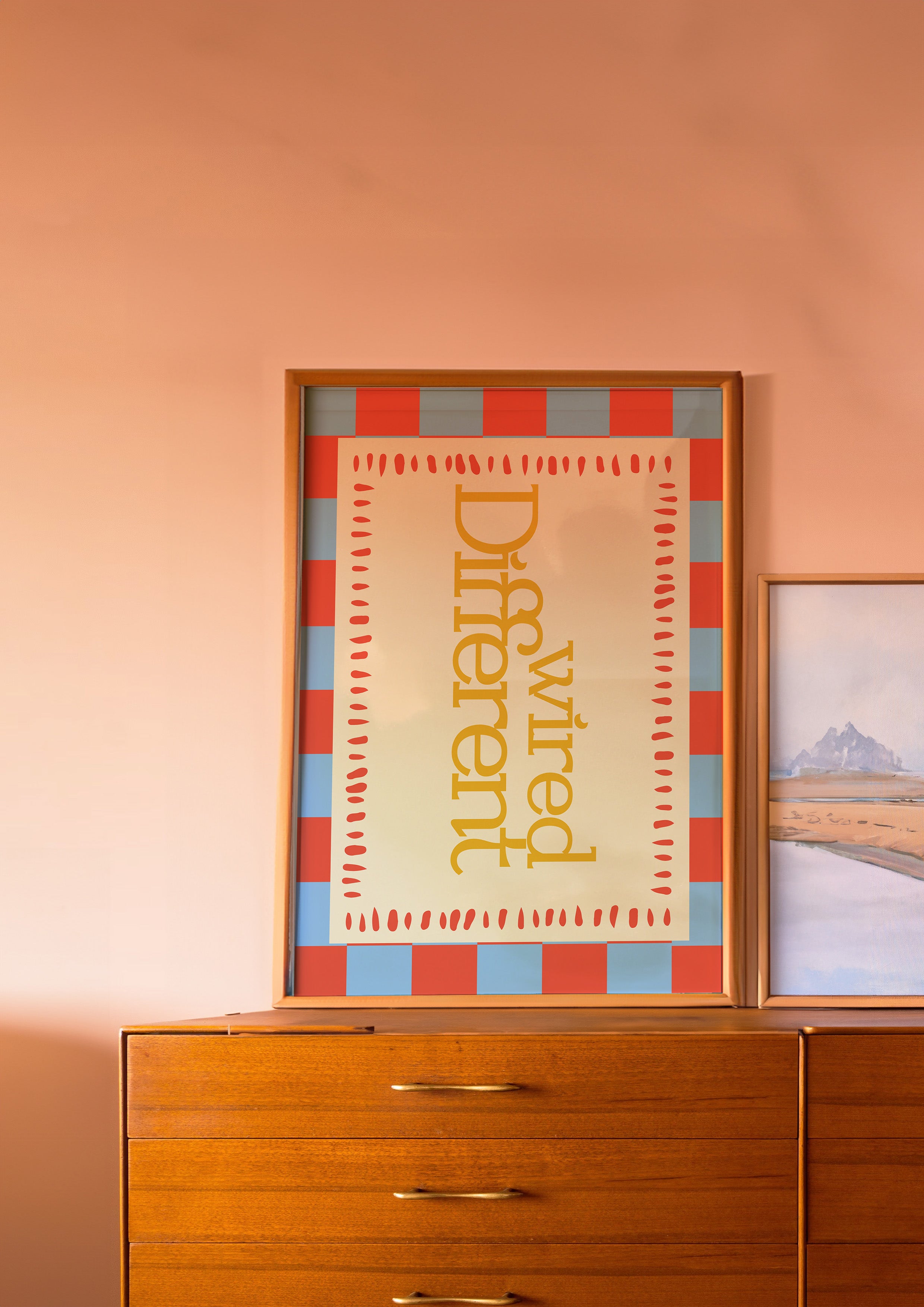 Wired Different 24x36 mental health wall art poster leaning on a wooden dresser against a blush wall